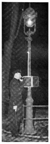 Police Officer Standing by Pole with Call Box